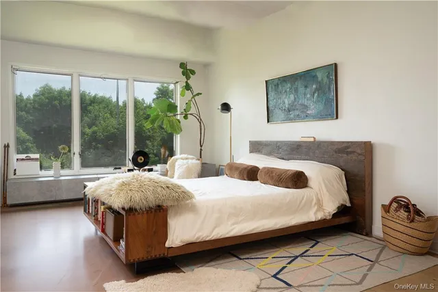 a bedroom with a bed table and a window