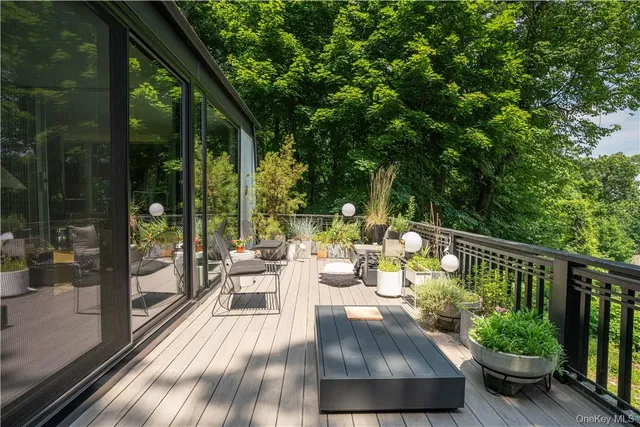 a view of balcony with furniture and garden