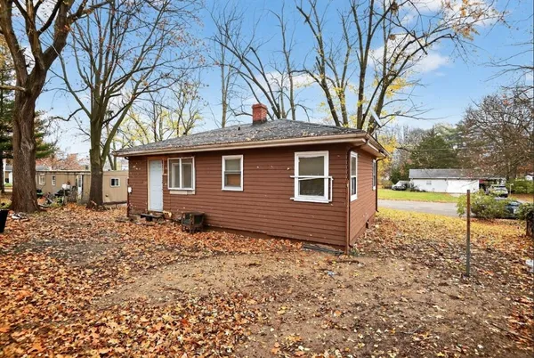 a backyard of a house with large trees