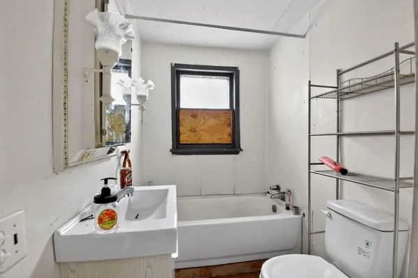 a bathroom with a bathtub sink and toilet