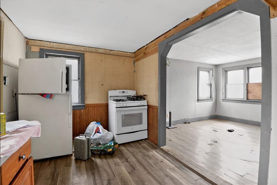 210 South High Street Havana, IL 62644 - Photo 8 of 17 a room with furniture a window and a wooden floor