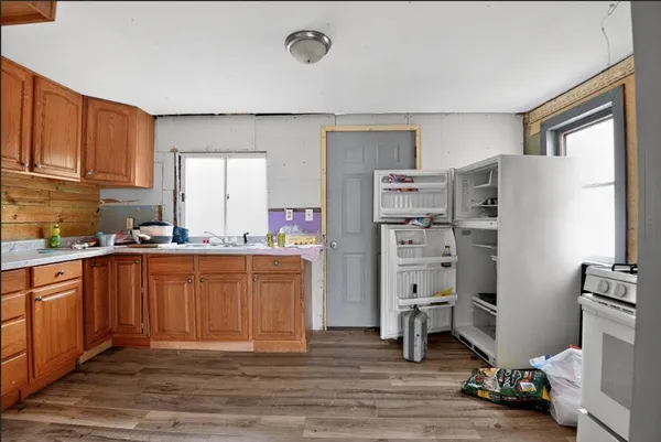a kitchen with stainless steel appliances a refrigerator and a stove top oven