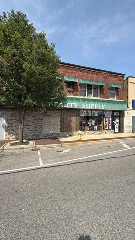 a view of building with large trees and playing court