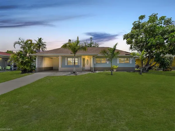 a front view of house with a garden