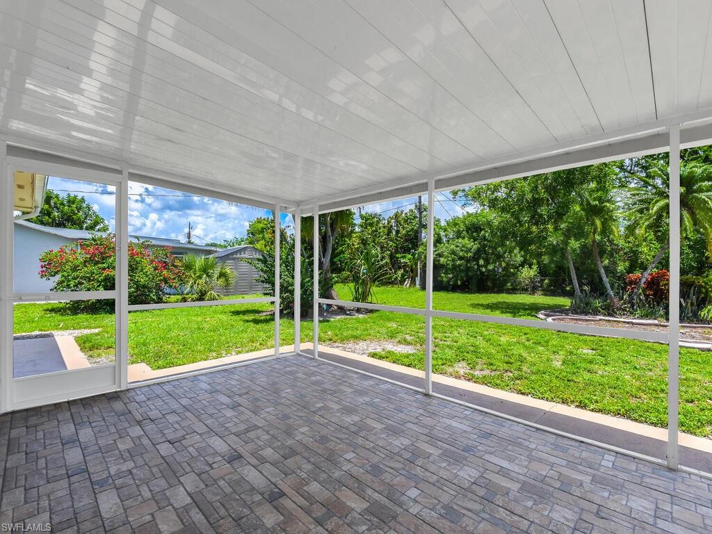 1958 41st Terrace Southwest Naples, FL 34116 - Photo 11 of 28 a view of a yard with porch and wooden fence