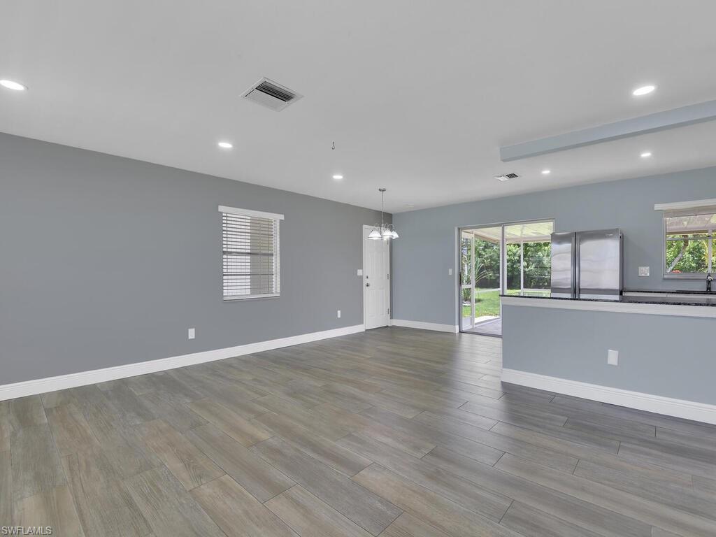 1958 41st Terrace Southwest Naples, FL 34116 - Photo 13 of 28 a view of an empty room with wooden floor and a window