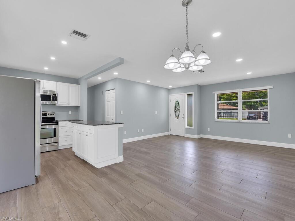1958 41st Terrace Southwest Naples, FL 34116 - Photo 15 of 28 a view of an empty room with kitchen and window