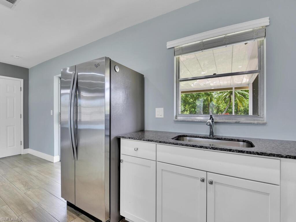 1958 41st Terrace Southwest Naples, FL 34116 - Photo 18 of 28 a kitchen with a refrigerator and a sink