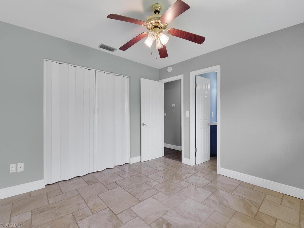 1958 41st Terrace Southwest Naples, FL 34116 - Photo 19 of 28 a view of an empty room and chandelier fan