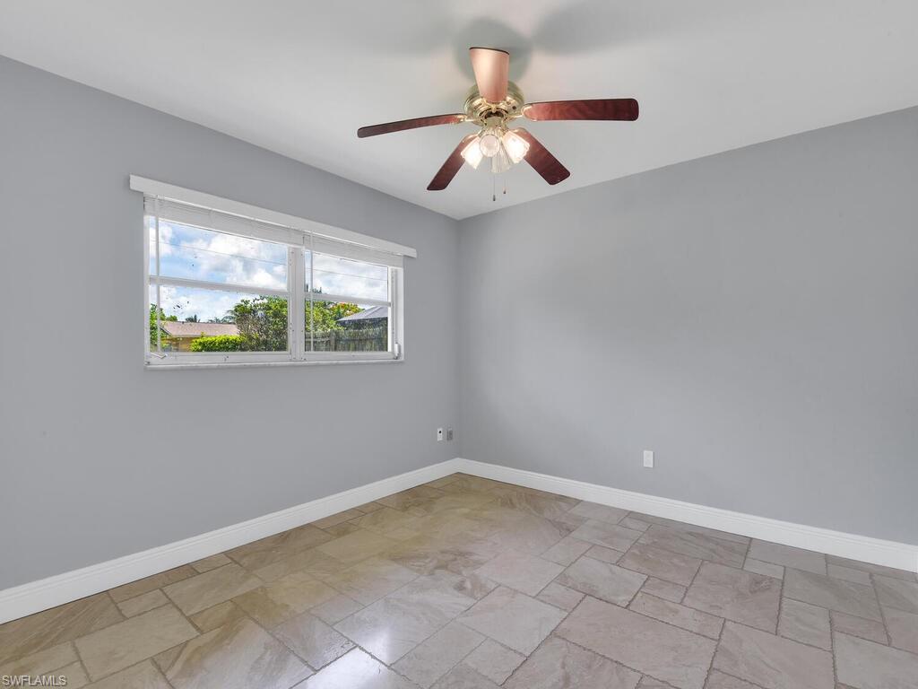 1958 41st Terrace Southwest Naples, FL 34116 - Photo 20 of 28 an empty room with windows and fan