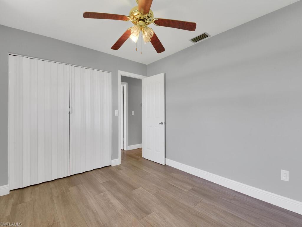 1958 41st Terrace Southwest Naples, FL 34116 - Photo 23 of 28 a view of an empty room with wooden floor