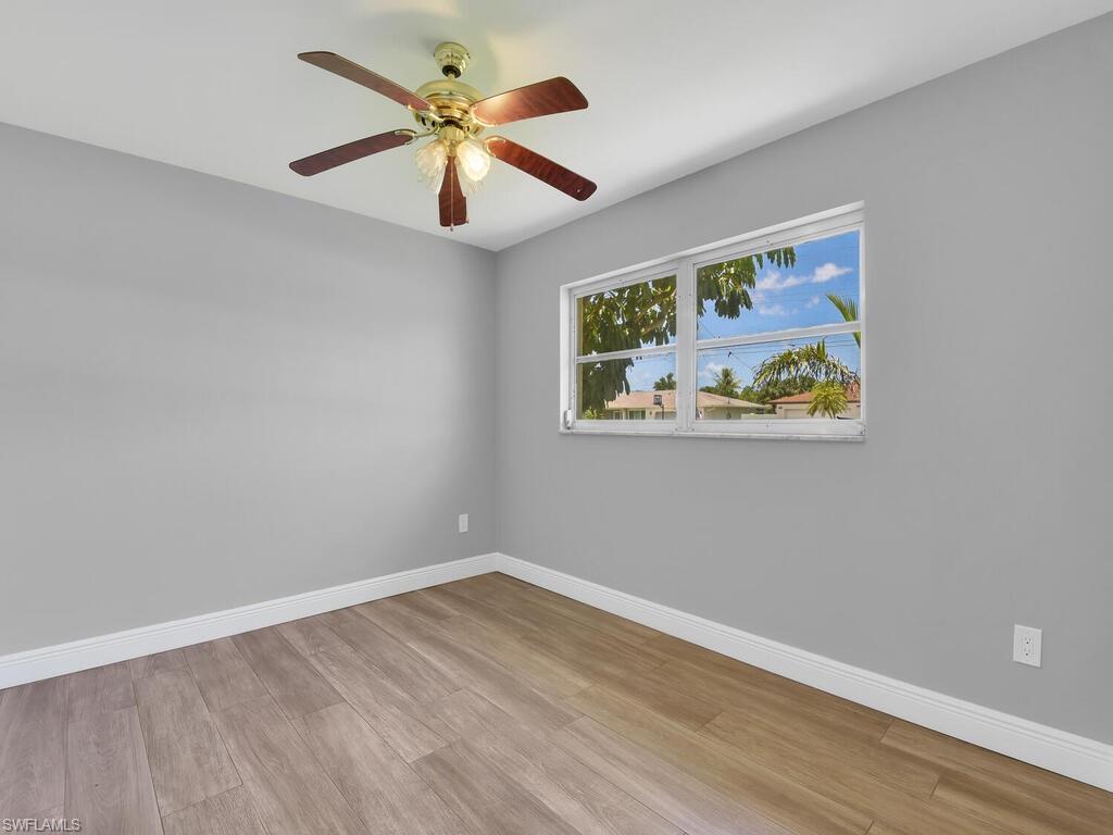 1958 41st Terrace Southwest Naples, FL 34116 - Photo 24 of 28 a view of room with wooden floor and ceiling fan