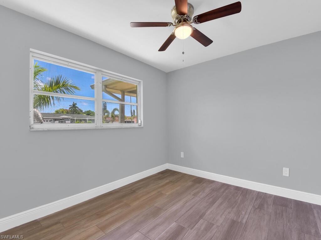 1958 41st Terrace Southwest Naples, FL 34116 - Photo 25 of 28 a view of empty room with wooden floor and fan