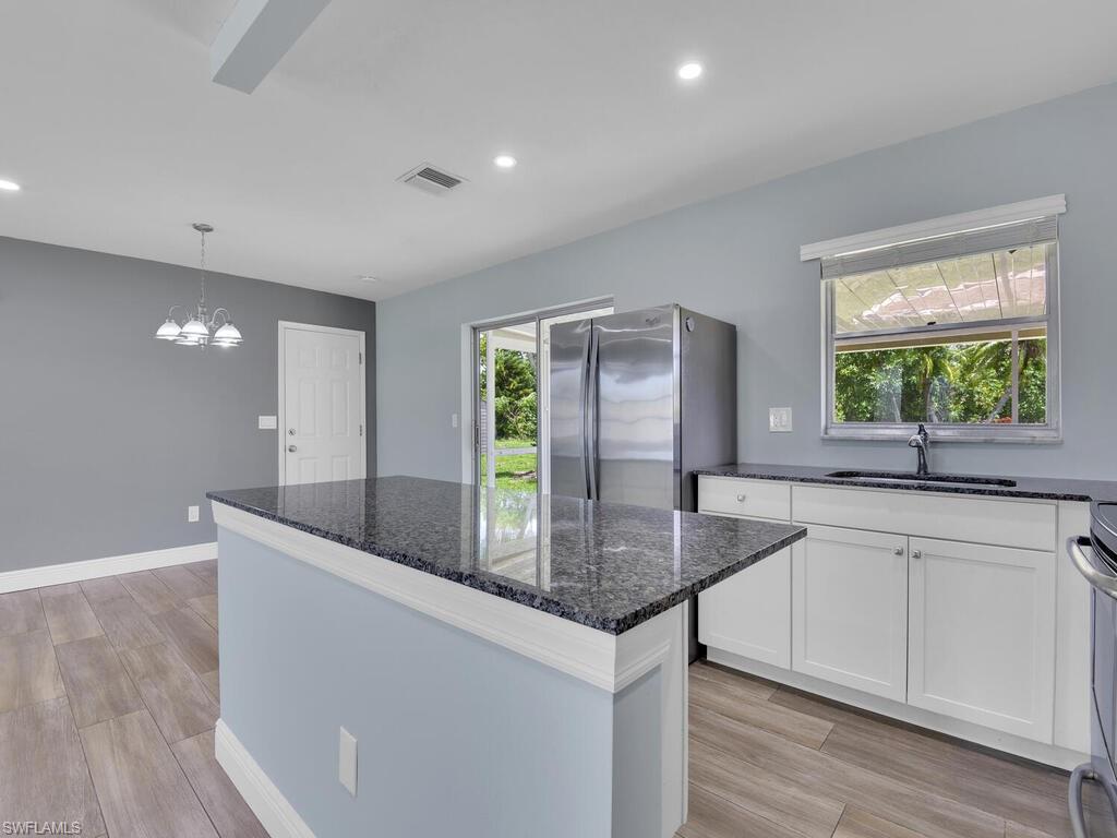 1958 41st Terrace Southwest Naples, FL 34116 - Photo 3 of 28 a kitchen with stainless steel appliances granite countertop a sink and a granite counter tops