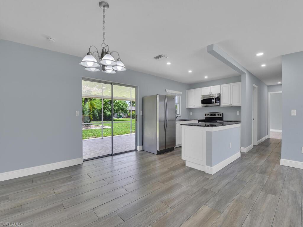 1958 41st Terrace Southwest Naples, FL 34116 - Photo 4 of 28 a view of kitchen with refrigerator microwave and stove top oven