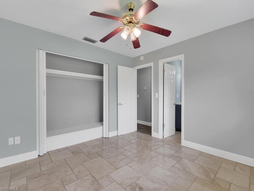 1958 41st Terrace Southwest Naples, FL 34116 - Photo 6 of 28 a view of an empty room and chandelier fan