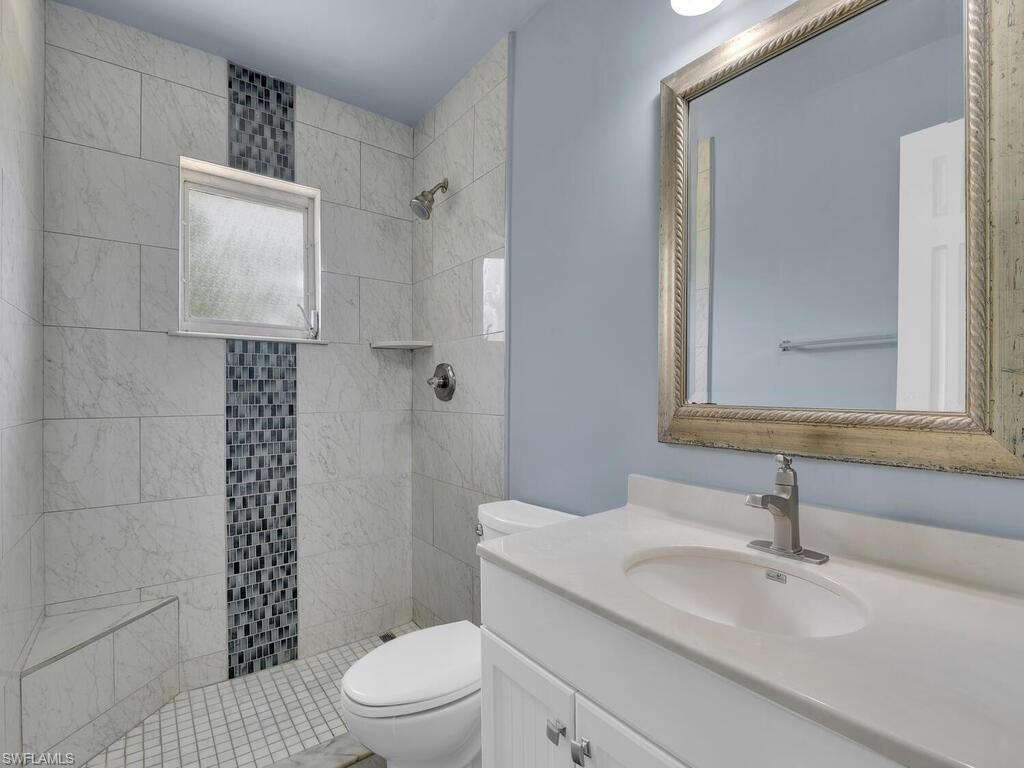 1958 41st Terrace Southwest Naples, FL 34116 - Photo 7 of 28 a bathroom with a sink a toilet and shower