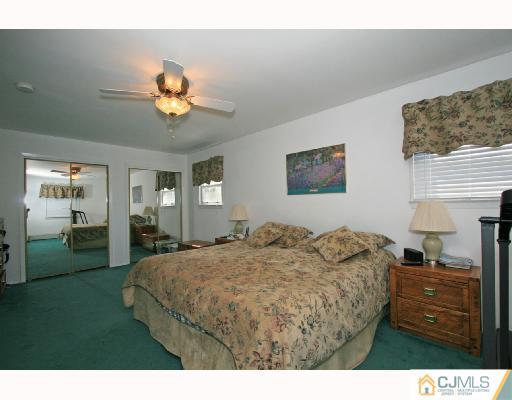 15 King Road Somerset, NJ 08873 - Photo 6 of 8 a bedroom with a bed and a chandelier