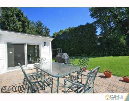 15 King Road Somerset, NJ 08873 - Photo 7 of 8 a view of a patio with a table chairs and a yard