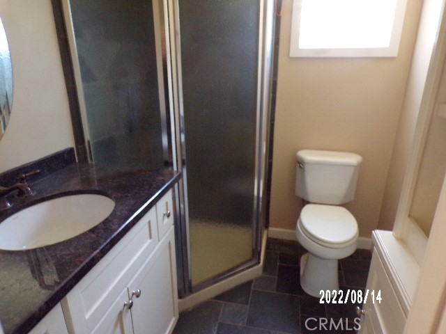 13425 Jensen Road Clearlake Oaks, CA 95423 - Photo 13 of 14 a bathroom with a granite countertop toilet and a sink