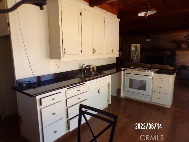 13425 Jensen Road Clearlake Oaks, CA 95423 - Photo 10 of 14 a kitchen with granite countertop white cabinets and white appliances