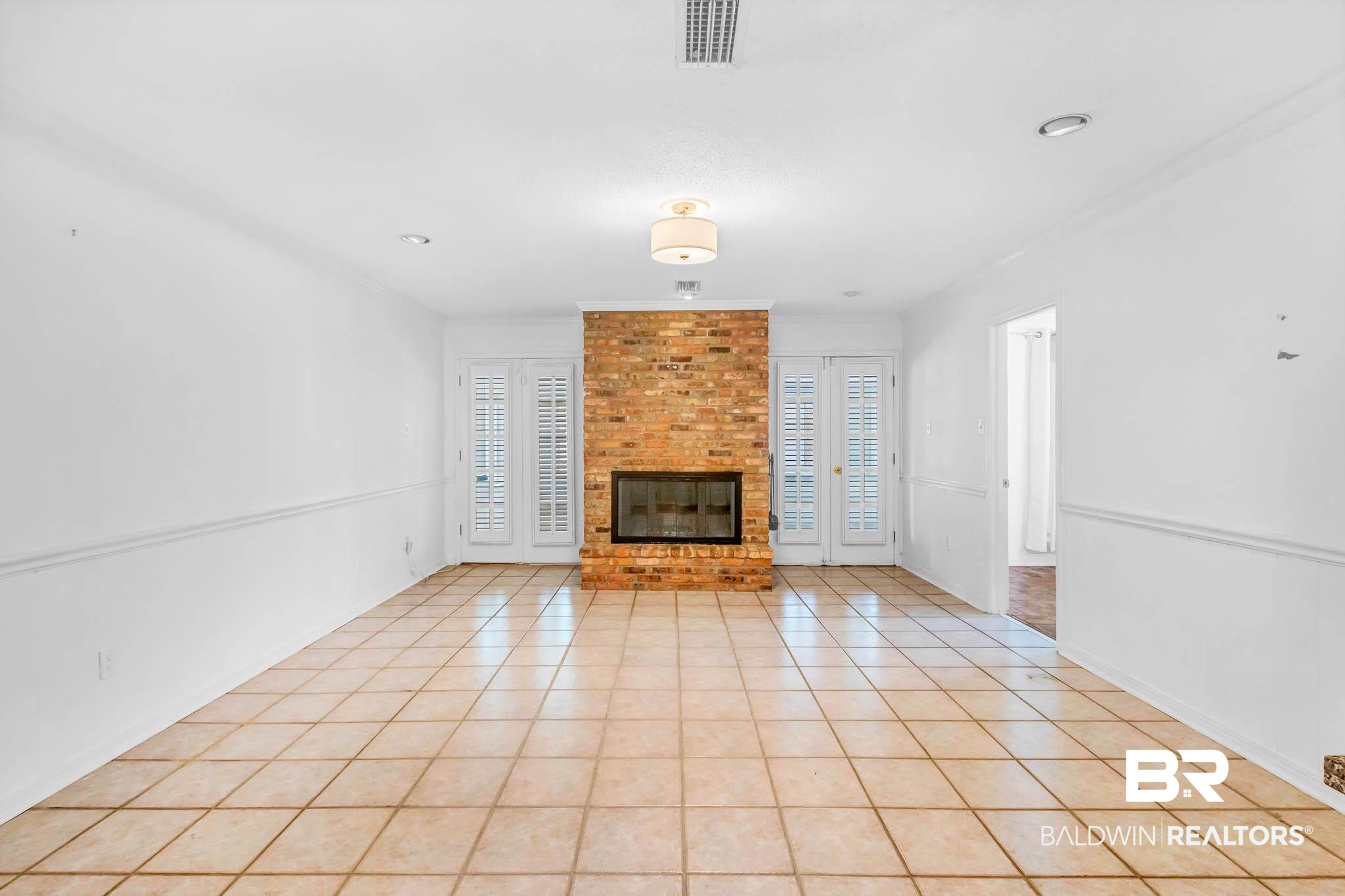309 West Brandy Run Road Mobile, AL 36608 - Photo 11 of 100 Unfurnished living room featuring a fireplace and light tile patterned floors