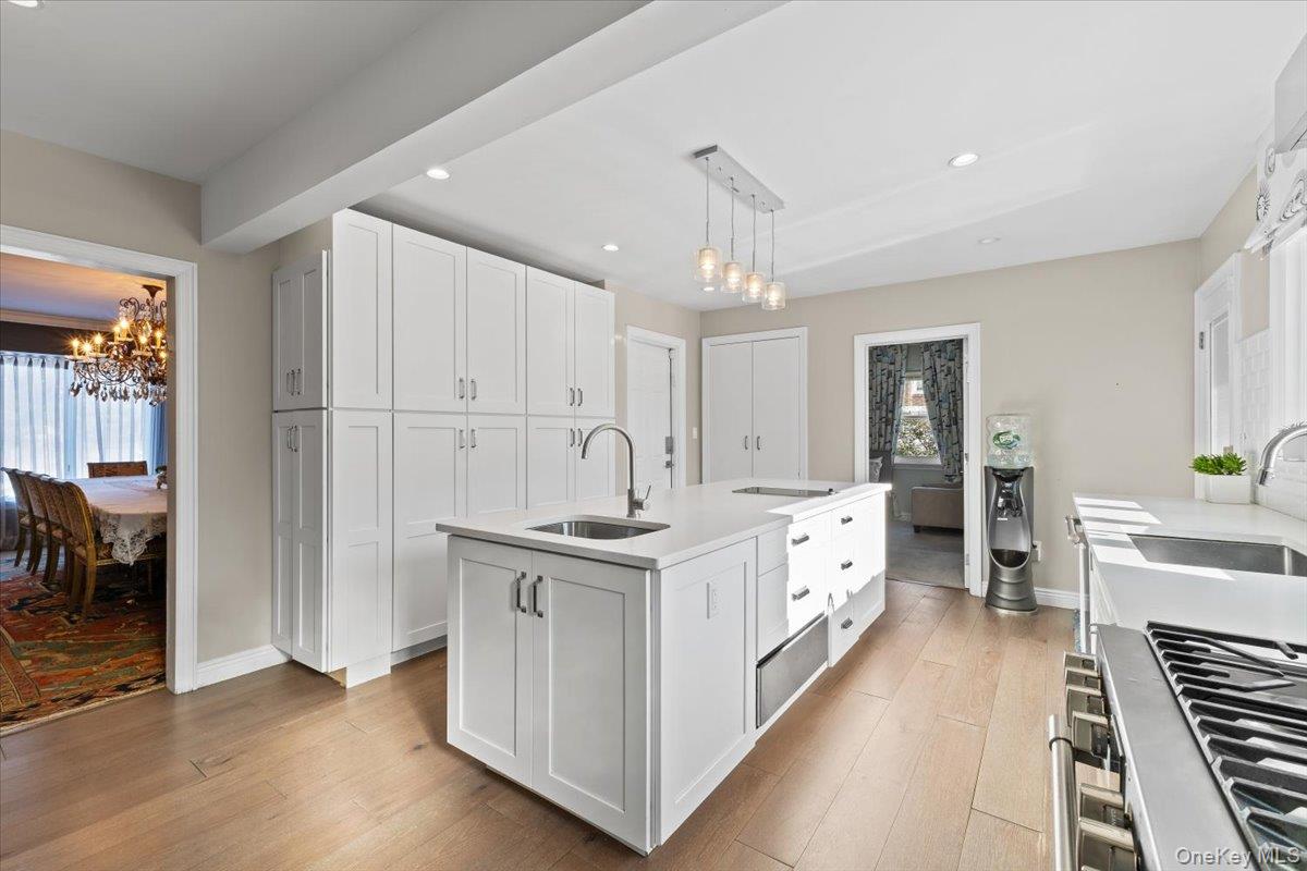25 Pond Park Road Great Neck, NY 11023 - Photo 15 of 45 a large white kitchen with stainless steel appliances granite countertop a stove and a sink