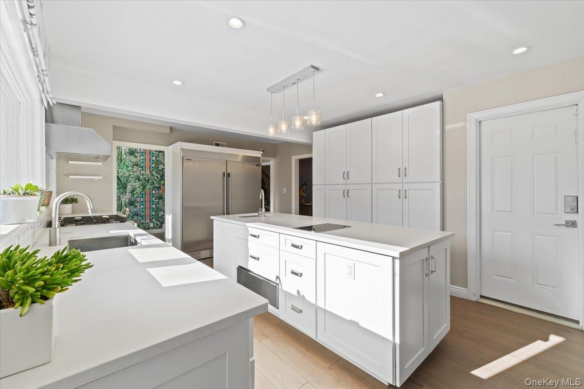 25 Pond Park Road Great Neck, NY 11023 - Photo 17 of 45 a kitchen with white cabinets and white appliances