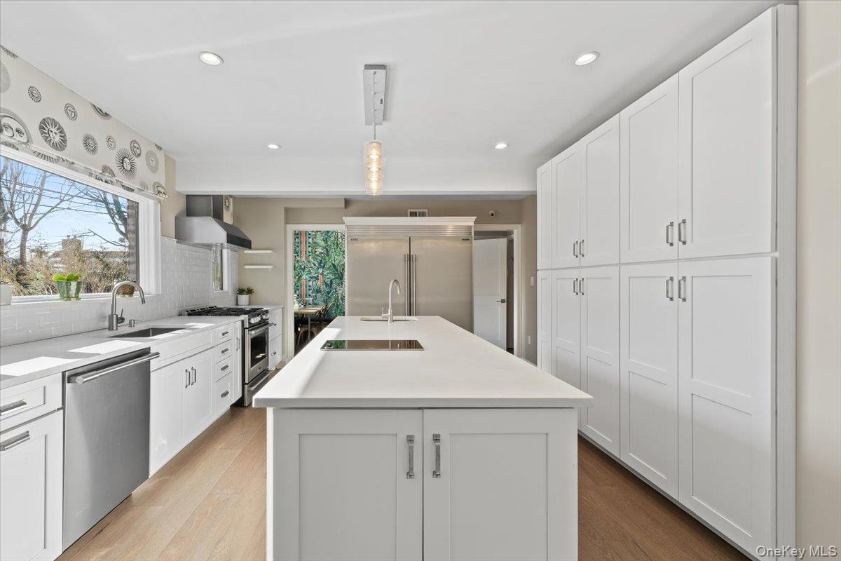 25 Pond Park Road Great Neck, NY 11023 - Photo 19 of 45 a kitchen with granite countertop white cabinets and white appliances