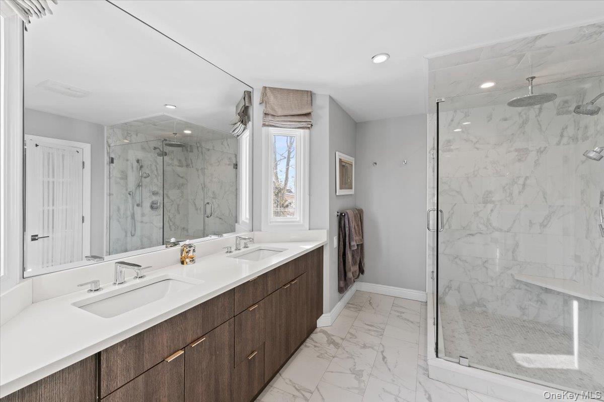 25 Pond Park Road Great Neck, NY 11023 - Photo 27 of 45 a bathroom with a double vanity sink mirror and shower