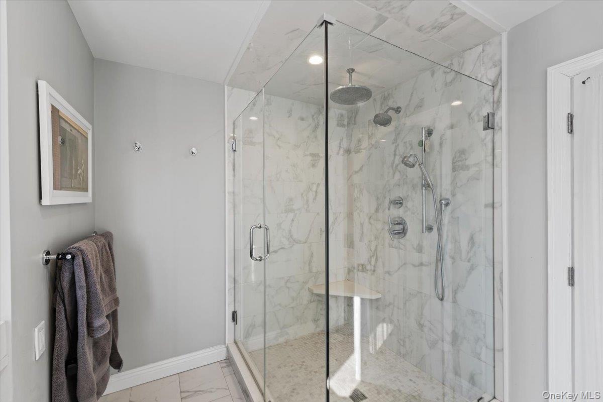 25 Pond Park Road Great Neck, NY 11023 - Photo 28 of 45 a bathroom with a shower and a glass door