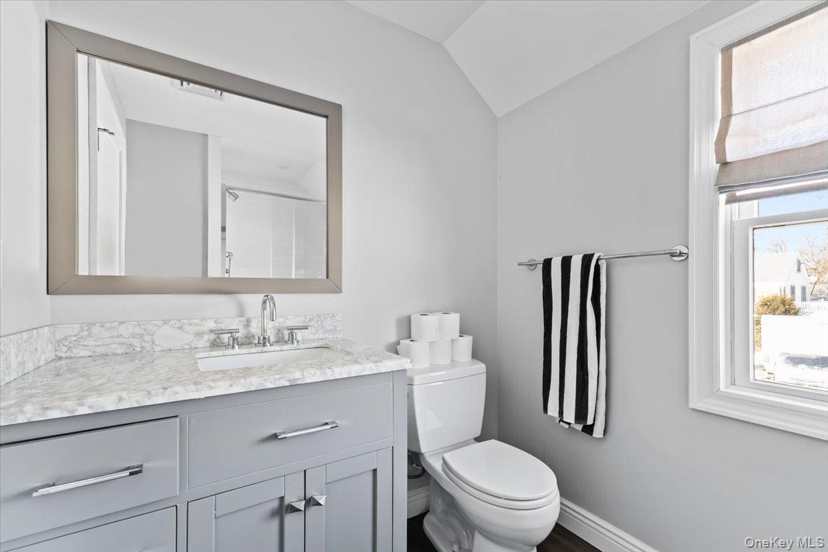 25 Pond Park Road Great Neck, NY 11023 - Photo 31 of 45 a bathroom with a granite countertop toilet sink and mirror