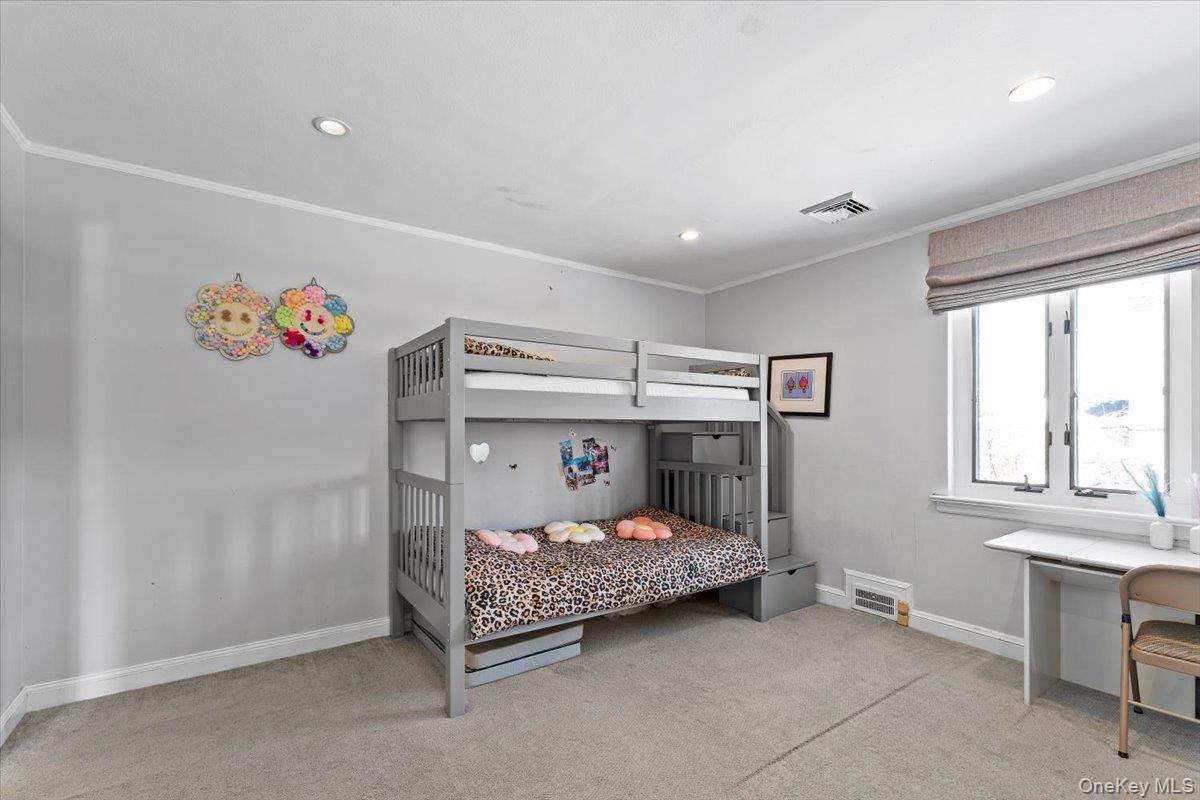 25 Pond Park Road Great Neck, NY 11023 - Photo 32 of 45 a bedroom with a bed and a window