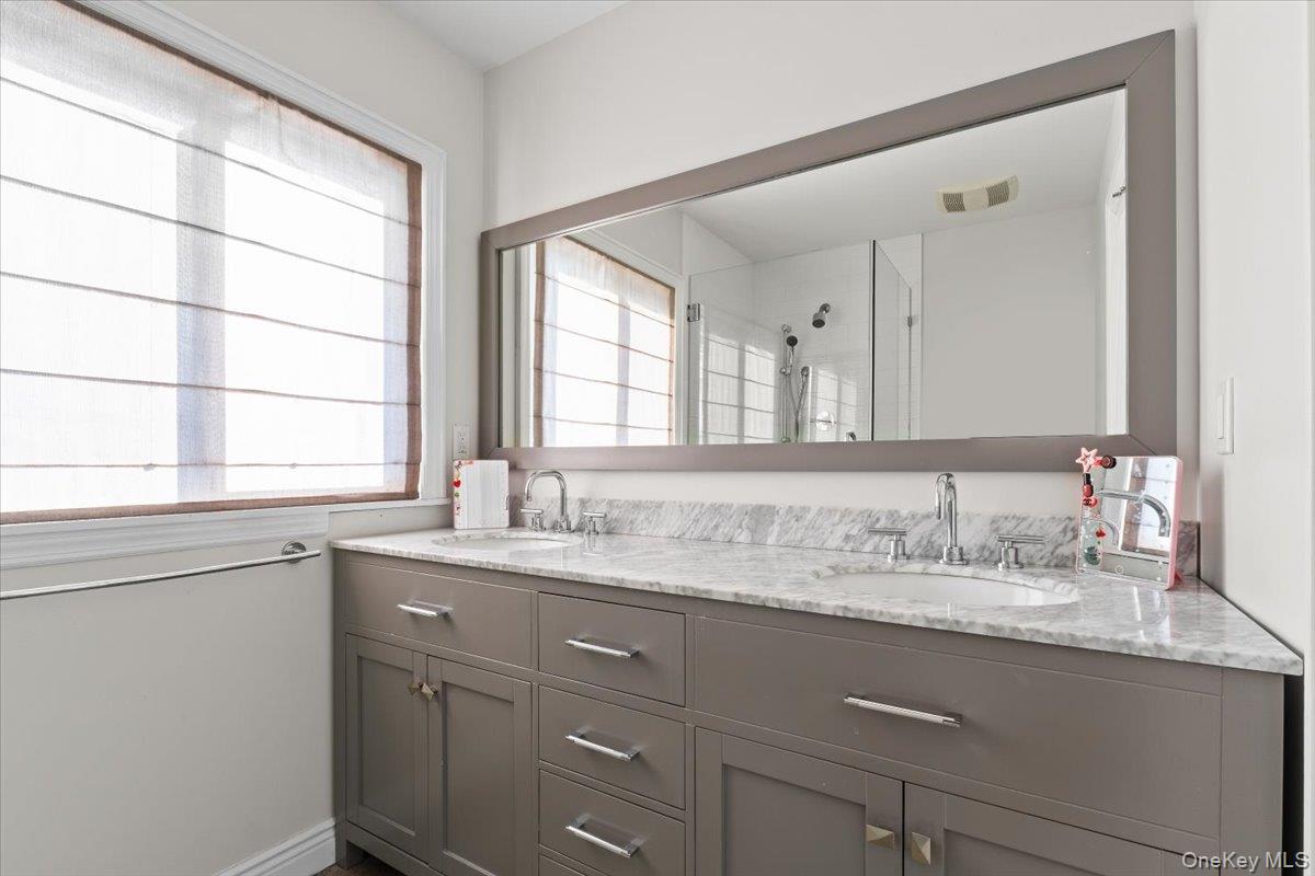 25 Pond Park Road Great Neck, NY 11023 - Photo 36 of 45 a bathroom with a granite countertop sink mirror and a window