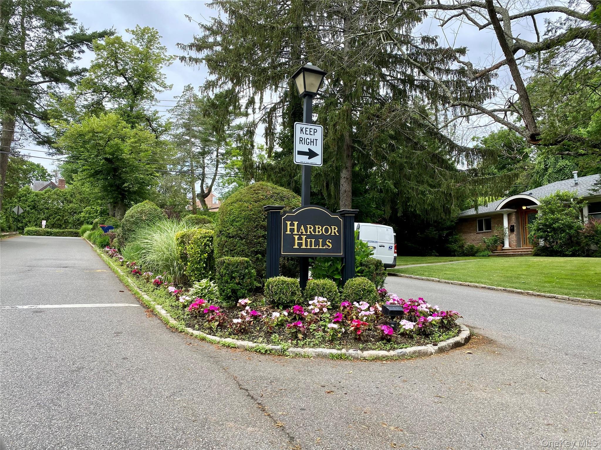 25 Pond Park Road Great Neck, NY 11023 - Photo 43 of 45 a sign that is sitting in front of flowers