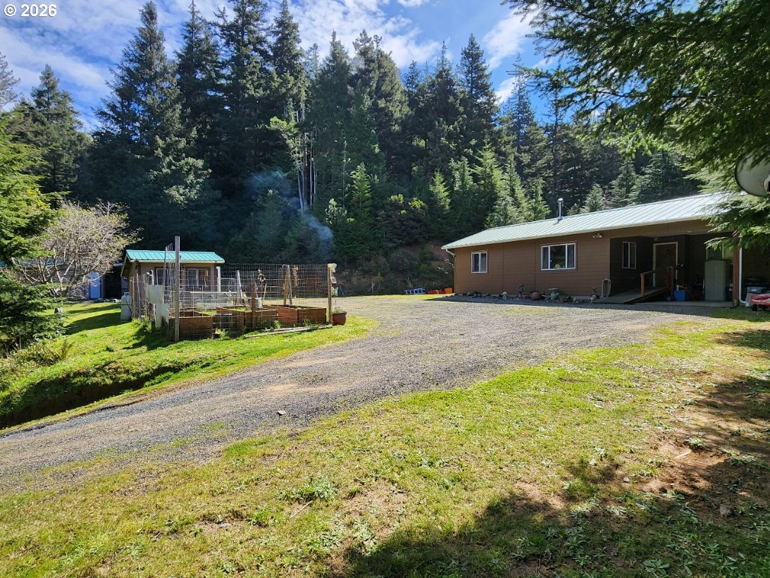 93490 Fir Road Port Orford, OR 97465 - Photo 1 of 47 a view of a house with pool and a yard