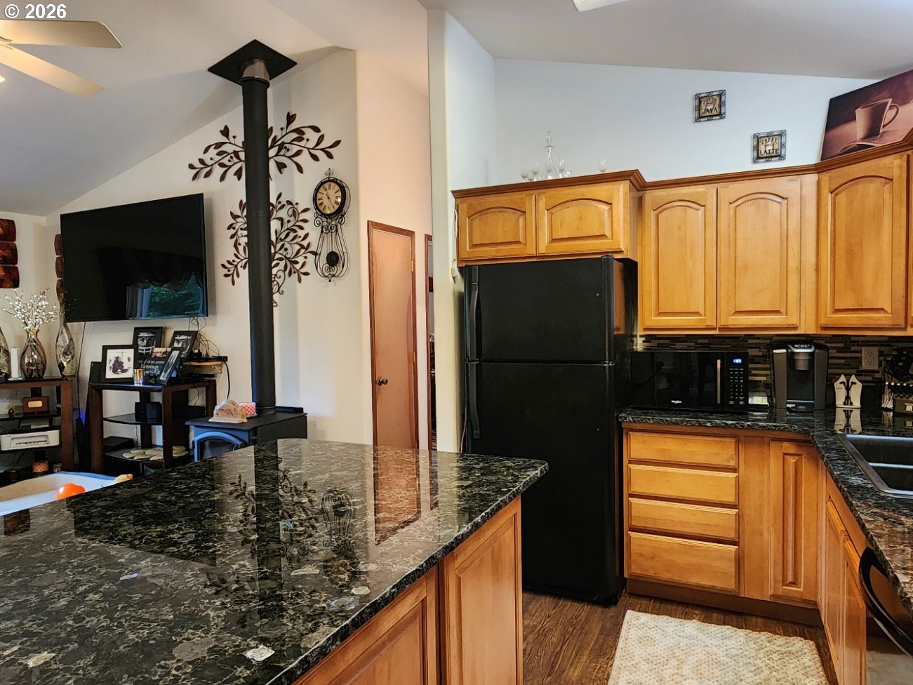 93490 Fir Road Port Orford, OR 97465 - Photo 11 of 47 a kitchen with stainless steel appliances granite countertop a refrigerator and a stove top oven