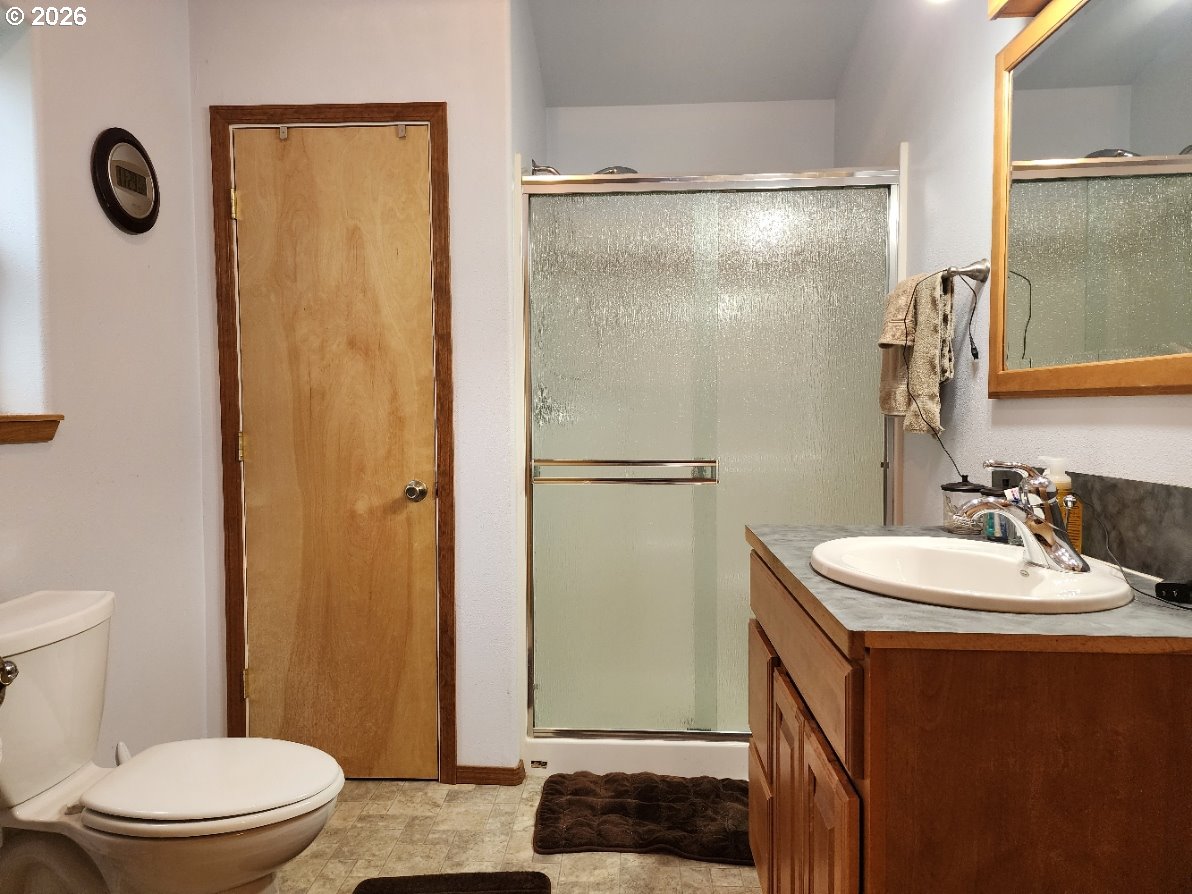 93490 Fir Road Port Orford, OR 97465 - Photo 18 of 47 a bathroom with a sink a toilet a mirror and shower