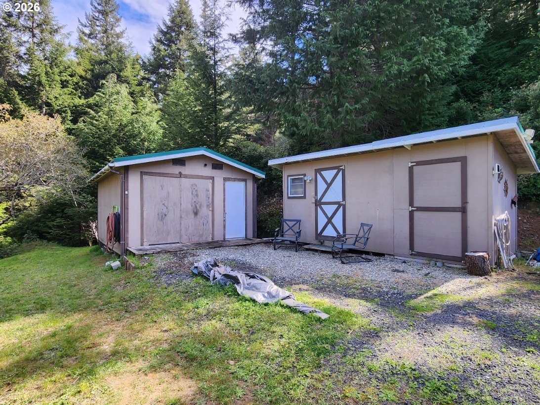 93490 Fir Road Port Orford, OR 97465 - Photo 29 of 47 a wooden house with a yard and large trees