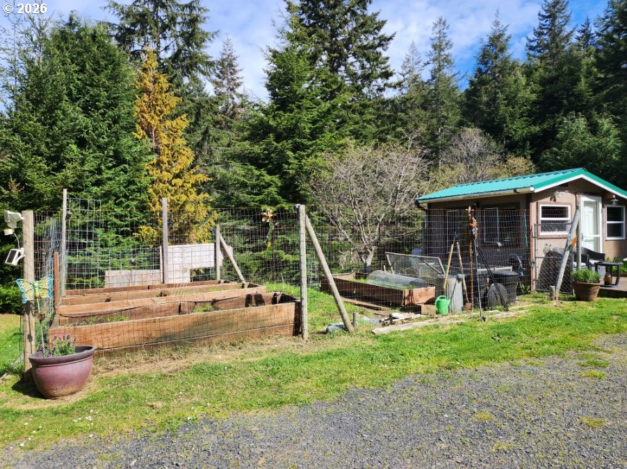 93490 Fir Road Port Orford, OR 97465 - Photo 31 of 47 a view of a house with backyard sitting area and garden