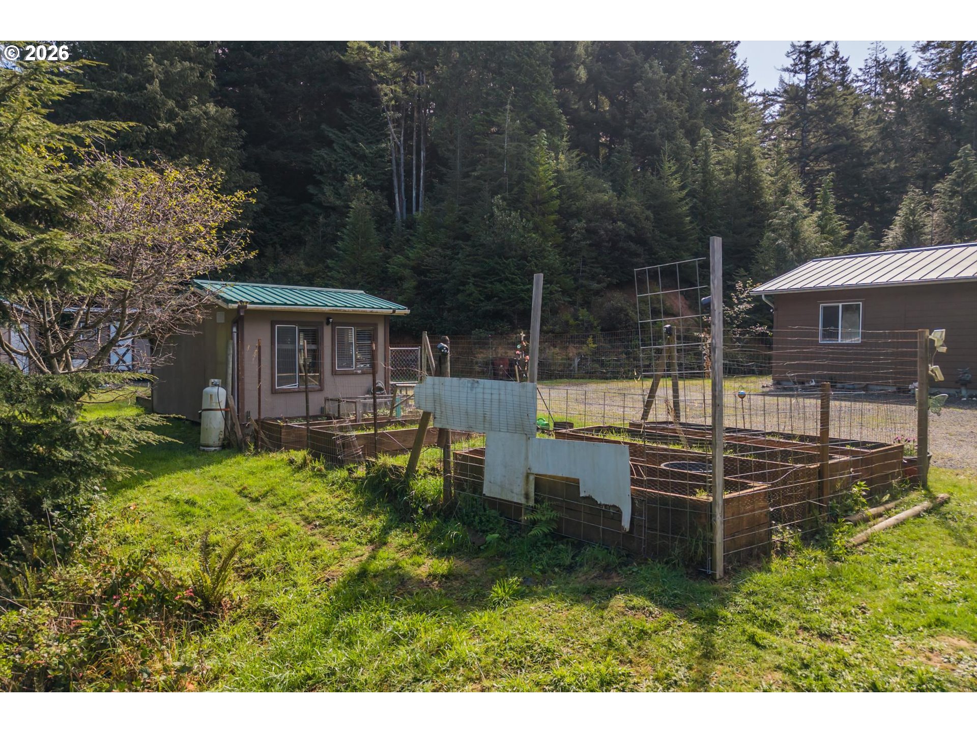 93490 Fir Road Port Orford, OR 97465 - Photo 39 of 47 a view of a house with backyard sitting area and garden