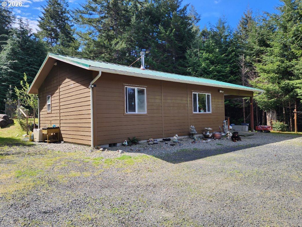 93490 Fir Road Port Orford, OR 97465 - Photo 47 of 47 a view of a house with backyard and sitting area