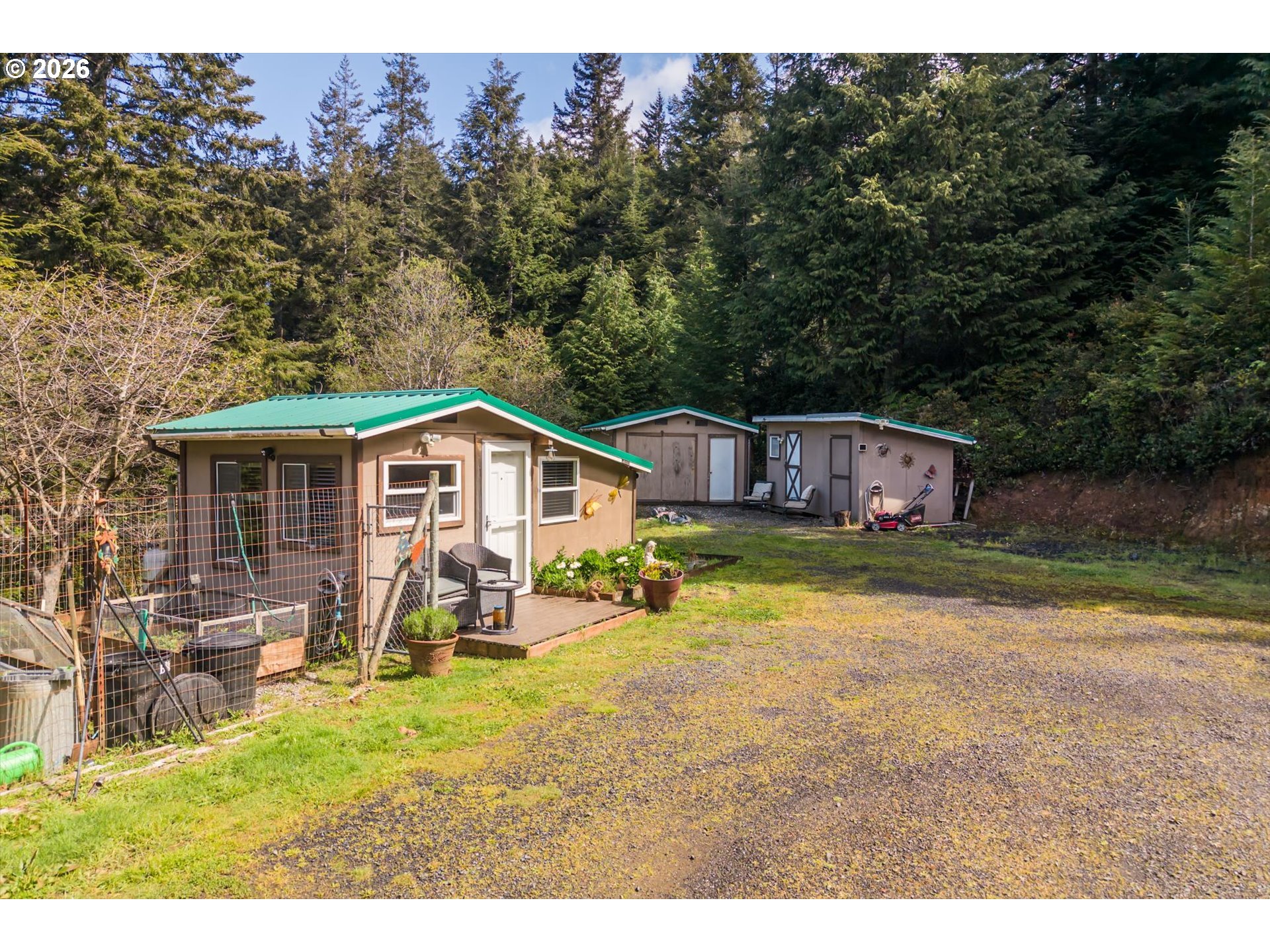 93490 Fir Road Port Orford, OR 97465 - Photo 5 of 47 a backyard of a house with table and chairs
