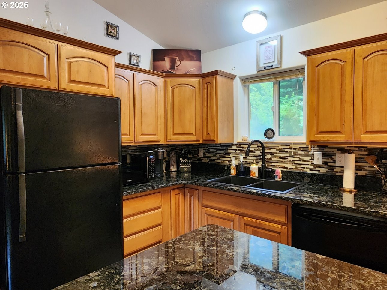 93490 Fir Road Port Orford, OR 97465 - Photo 9 of 47 a kitchen with stainless steel appliances granite countertop a refrigerator a sink dishwasher a stove and a dining table with wooden floor