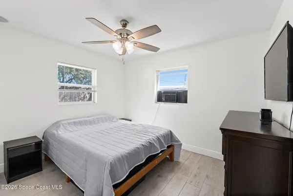 a bedroom with a bed and a flat screen tv