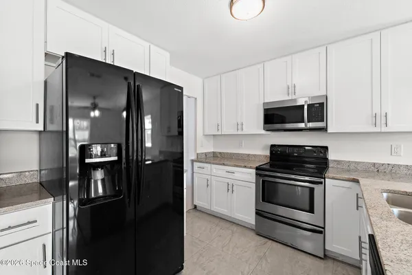 a kitchen with stainless steel appliances and refrigerator