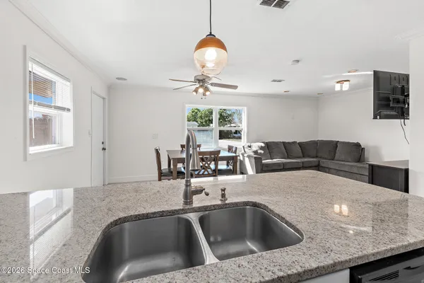 a kitchen with a table chairs and a chandelier