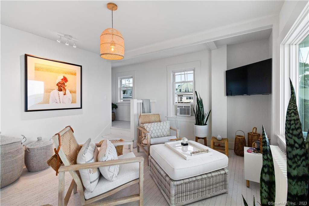 19 Soundview Drive Westport, CT 06880 - Photo 14 of 40 a living room with furniture a flat screen tv and a window