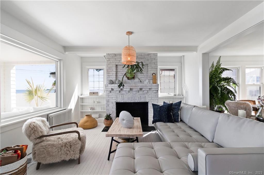 19 Soundview Drive Westport, CT 06880 - Photo 15 of 40 a living room with furniture a fireplace and a large window