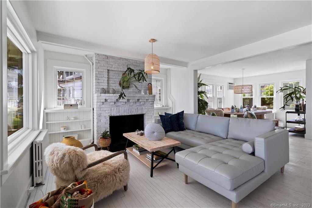 19 Soundview Drive Westport, CT 06880 - Photo 16 of 40 a living room with furniture a fireplace and a large window